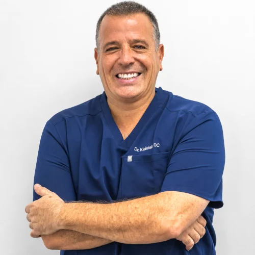 A professional headshot of Dr. Kleinfeld, DC, a leading chiropractor at Revive Spine and Wellness in Jupiter, Florida.